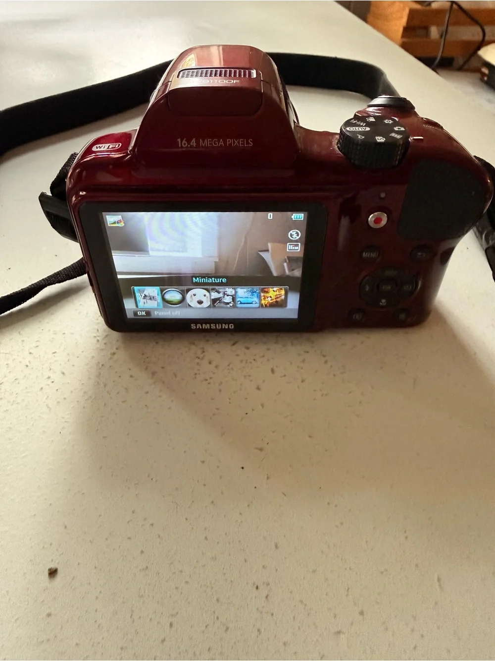 Samsung glossy red digital bridge camera with Samsung lens